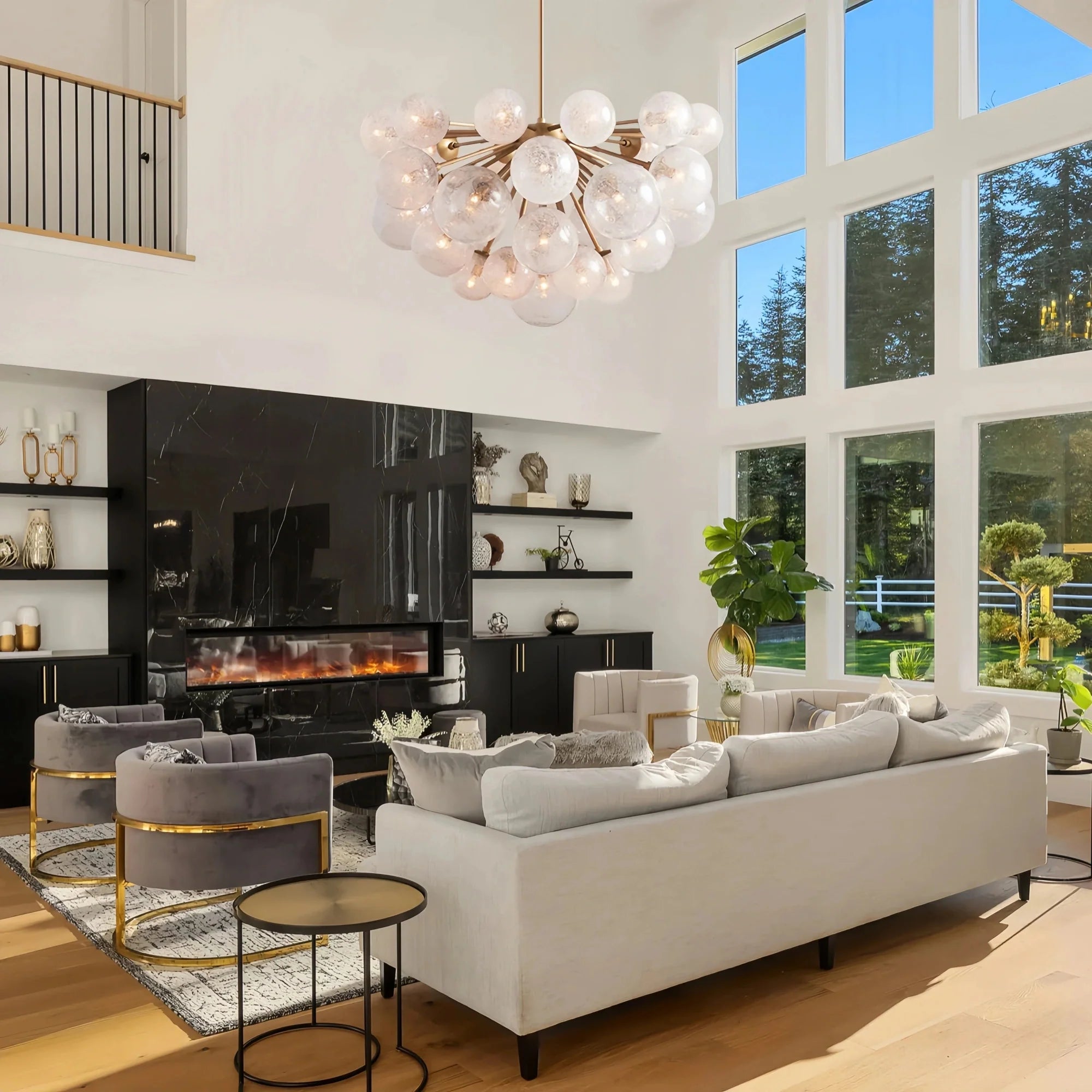 Modern living room with a white sofa, gray chairs, and a large window.